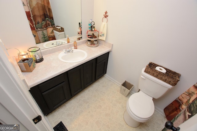 bathroom featuring vanity and toilet