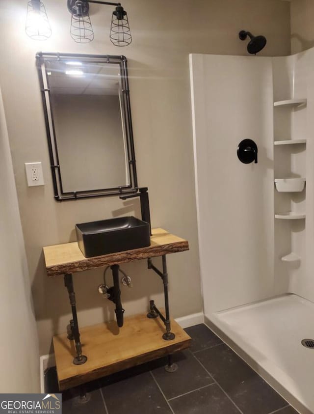 bathroom with tile patterned floors, sink, and walk in shower