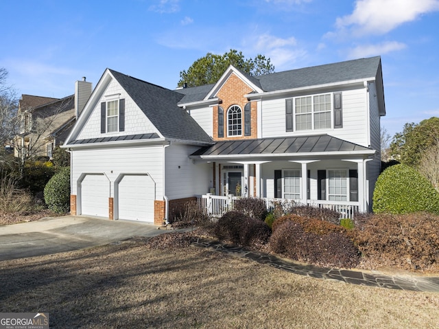 2352 Kelman Pl, Dacula, GA 30019 - traditional-style home with a porch, a standing seam roof, concrete driveway, brick siding, and a chimney