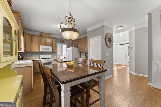 2352 Kelman Pl, Dacula, GA 30019 - dining space with light wood-type flooring, ornamental molding, and baseboards
