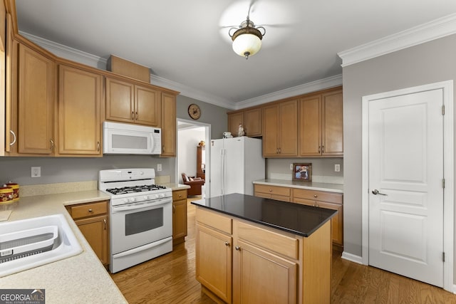 kitchen with crown molding, a kitchen island, hardwood / wood-style floors, and white appliances