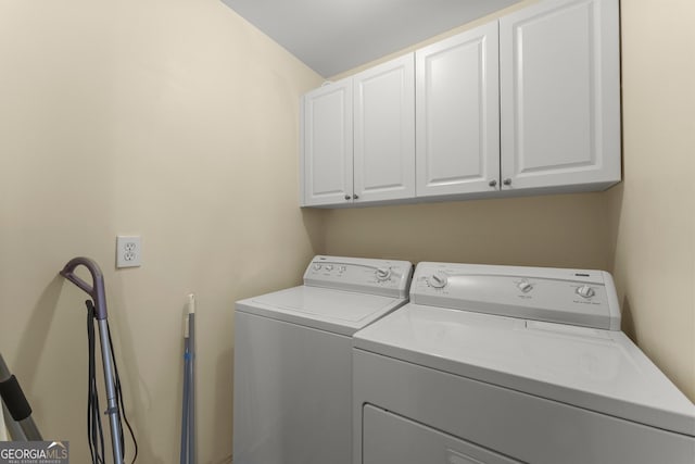 2352 Kelman Pl, Dacula, GA 30019 - clothes washing area with cabinet space and washing machine and clothes dryer