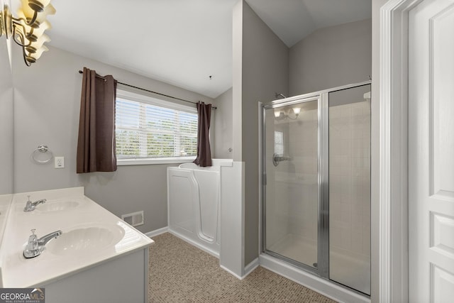 2352 Kelman Pl, Dacula, GA 30019 - bathroom with vaulted ceiling, a stall shower, baseboards, and double vanity