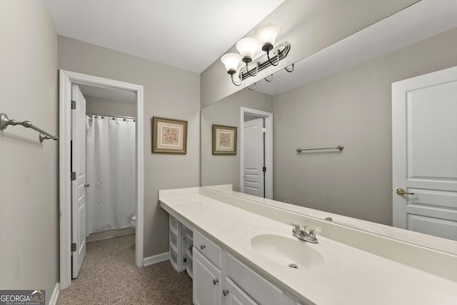 bathroom featuring a shower with curtain, vanity, and toilet