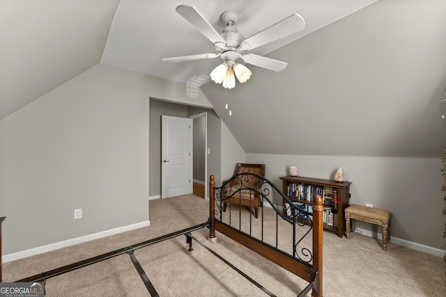 bedroom featuring vaulted ceiling, light carpet, and ceiling fan