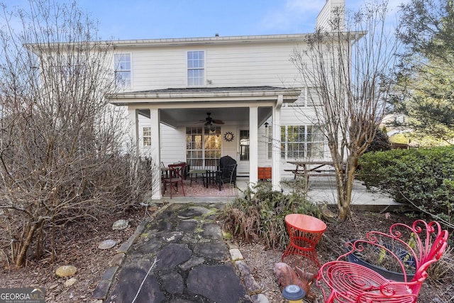 back of property with ceiling fan and a patio