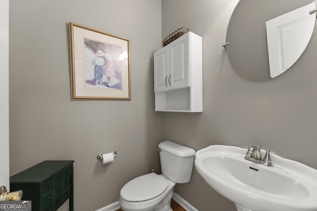 2352 Kelman Pl, Dacula, GA 30019 - half bathroom with a sink, toilet, and baseboards