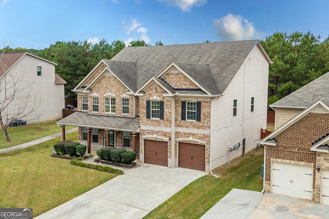 craftsman-style house with covered porch, a garage, central air condition unit, and a front lawn