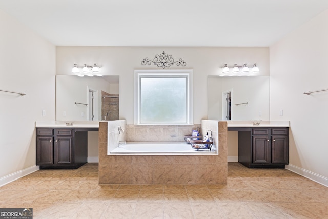 bathroom with tile patterned floors, vanity, and shower with separate bathtub