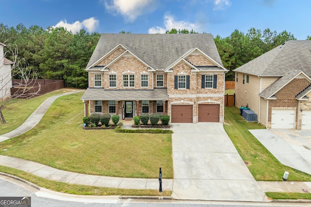 view of front of home featuring covered porch, a garage, central AC, and a front lawn