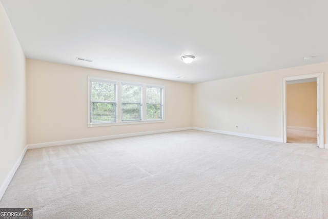 unfurnished room featuring light colored carpet