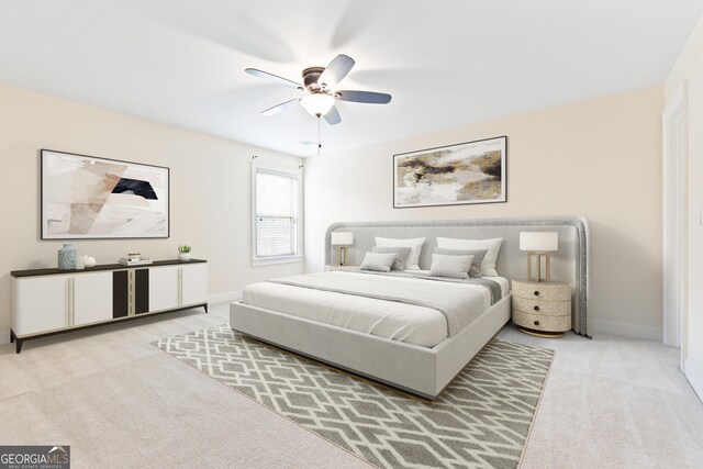 bedroom with ceiling fan and light carpet