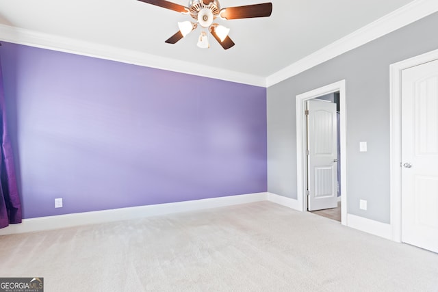 unfurnished bedroom featuring ceiling fan, carpet floors, and crown molding