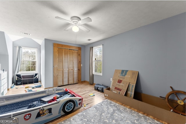 bedroom featuring a closet, ceiling fan, and light hardwood / wood-style floors