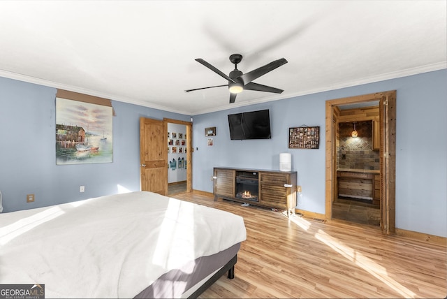 bedroom with hardwood / wood-style floors, ceiling fan, and crown molding