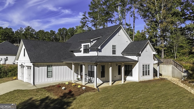 view of front of property featuring a garage, a patio area, and a front yard