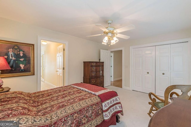 carpeted bedroom featuring ceiling fan and a closet