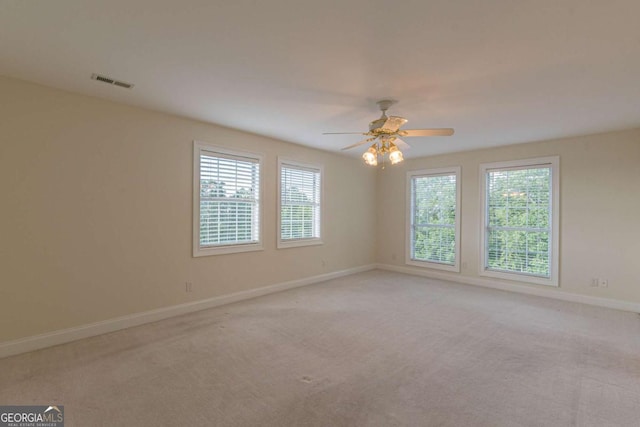 unfurnished room with ceiling fan and light colored carpet