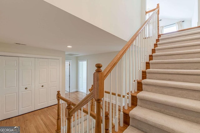 stairs featuring wood-type flooring