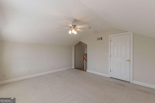 additional living space featuring light carpet, vaulted ceiling, and ceiling fan