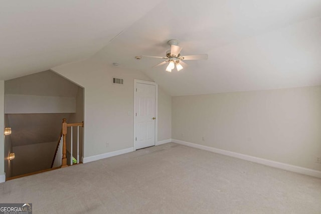 additional living space featuring ceiling fan, light carpet, and vaulted ceiling