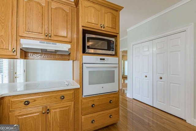 kitchen with white appliances and ornamental molding