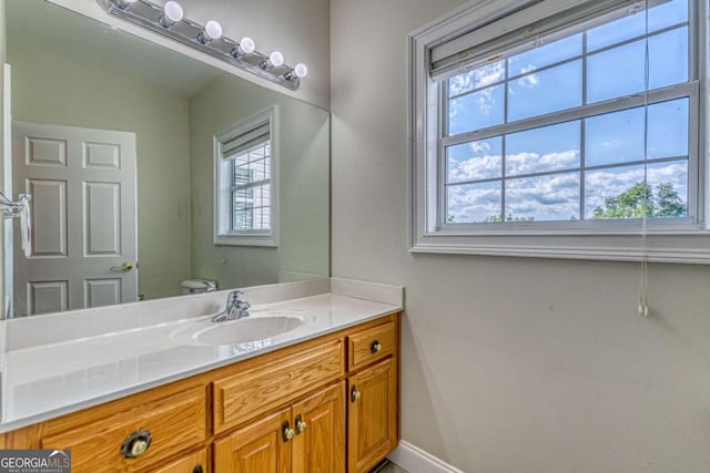 bathroom featuring vanity and toilet