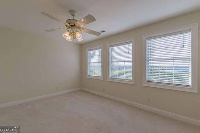 spare room featuring ceiling fan and light colored carpet