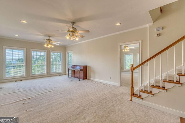 unfurnished living room featuring light carpet, ceiling fan, and ornamental molding