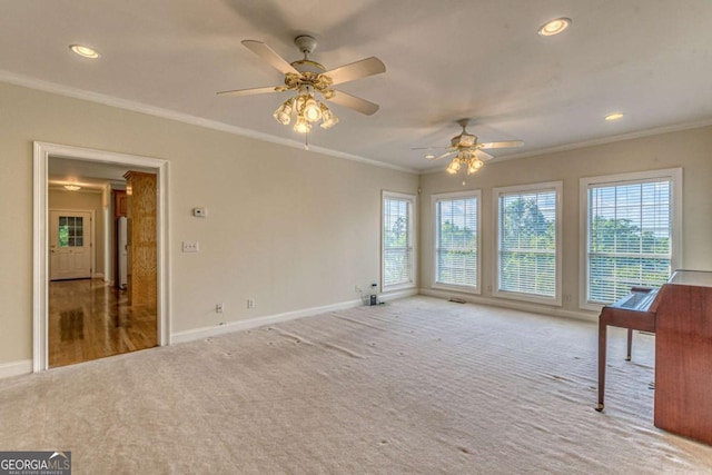 unfurnished living room with carpet floors, ceiling fan, and crown molding