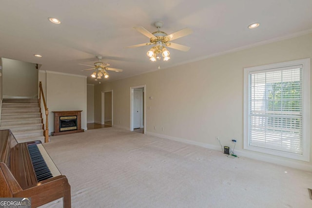 carpeted living room featuring ceiling fan and crown molding