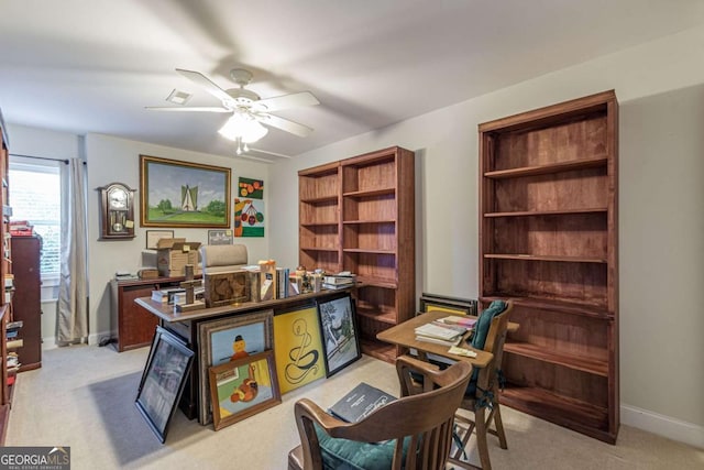 home office featuring ceiling fan and light colored carpet