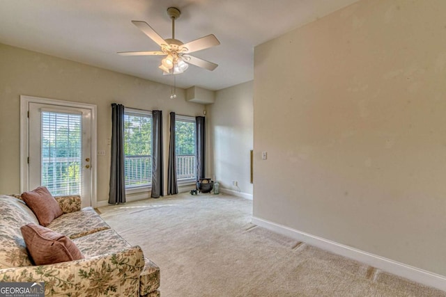 carpeted living room featuring ceiling fan