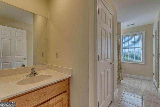 bathroom with tile patterned flooring and vanity