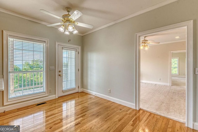 interior space featuring ceiling fan, light hardwood / wood-style flooring, and ornamental molding