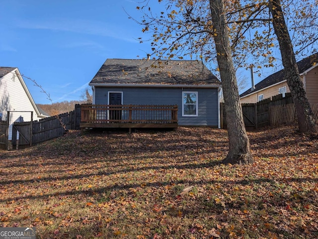 back of house featuring a wooden deck