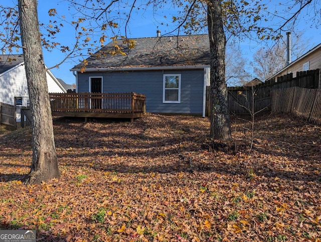 rear view of property featuring a wooden deck