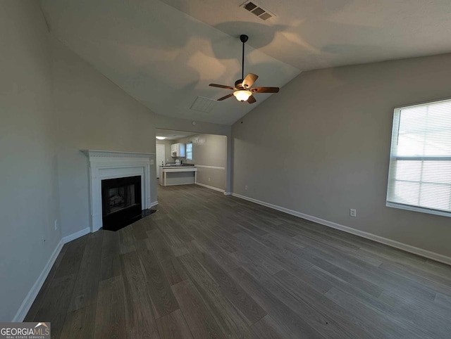 unfurnished living room featuring dark hardwood / wood-style floors, ceiling fan, and lofted ceiling