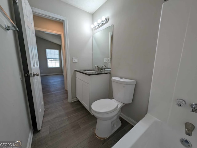 bathroom with hardwood / wood-style floors, vanity, and toilet