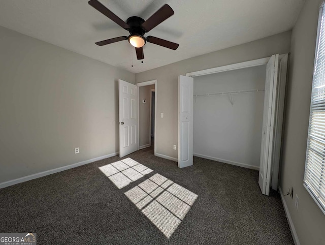 unfurnished bedroom featuring a closet, dark carpet, and ceiling fan