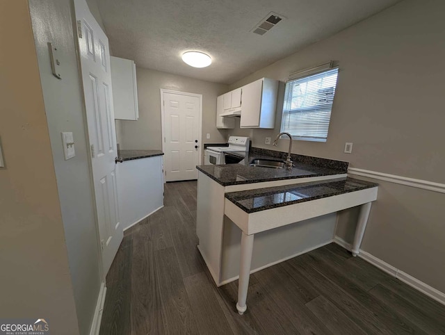 kitchen with white range with electric cooktop, sink, a textured ceiling, white cabinetry, and kitchen peninsula