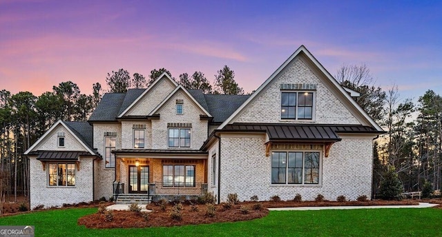 view of front of home featuring a lawn and covered porch