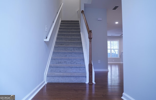 staircase with hardwood / wood-style floors