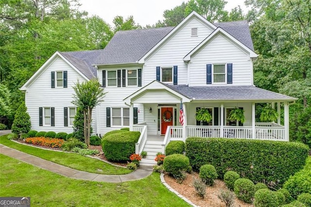 view of front of property with covered porch and a front lawn