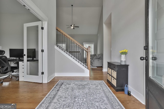 foyer entrance with ceiling fan and hardwood / wood-style floors