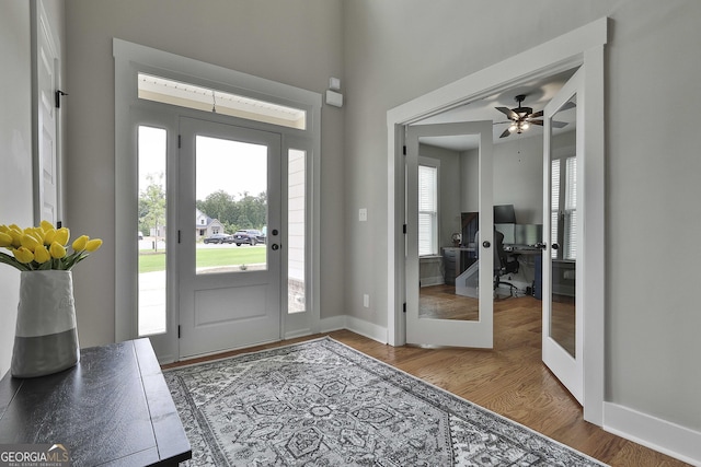 entryway featuring ceiling fan, plenty of natural light, french doors, and hardwood / wood-style flooring