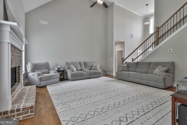 living room with a fireplace, hardwood / wood-style flooring, and high vaulted ceiling