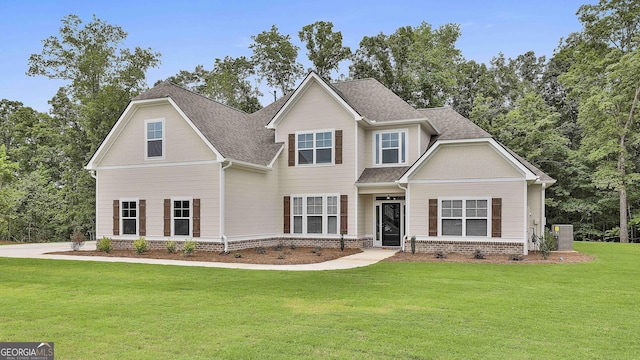 craftsman house with central AC unit and a front lawn