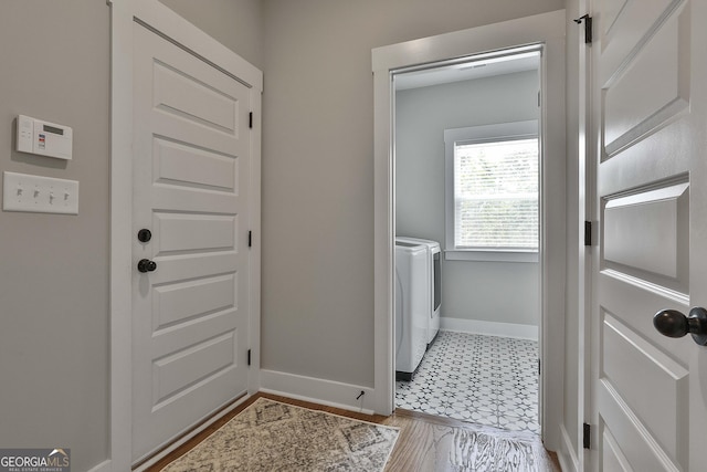 clothes washing area with washer and clothes dryer