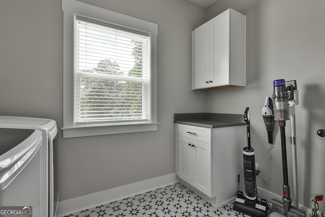 laundry room with cabinets and separate washer and dryer